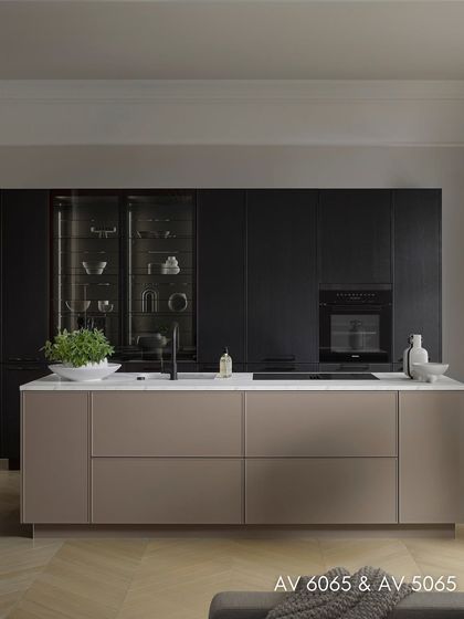 This image showcases the symphony of design and organization, with sensor-controlled glass elements, a high larder cupboard, and two-level pull-out drawers.