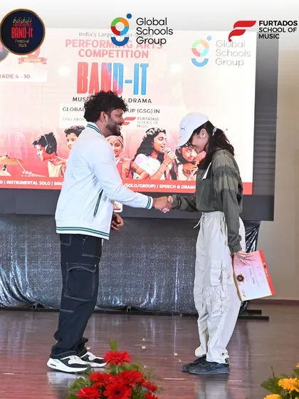 A hip-hop dancer is recognized for her performance at the Bangalore Band-It showdown. This photo highlights the diversity of dance styles we welcome and celebrate in our competition.