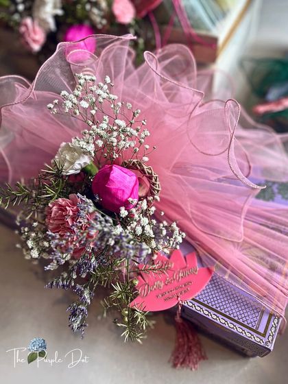 From my 'Gul & Gold' collection, this gift is wrapped in soft pink tulle and adorned with a delicate floral bouquet and a custom lotus tag. This collection is a gentle story whispered, not told, celebrating moments both timeless and bold.