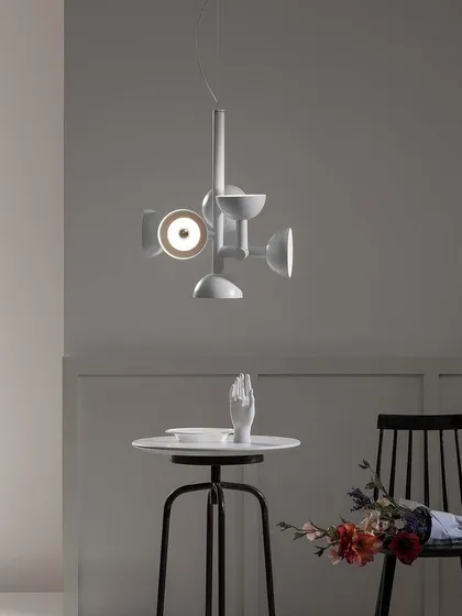 The Sibilla fixture is also available in white. Here, a smaller version adds a touch of modern, geometric design to a quiet corner.