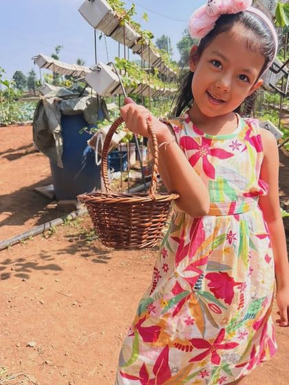 A perfect day for strawberry picking in our floral dress! It's light, comfortable, and doesn't get in the way of important activities like filling up a basket with goodies.