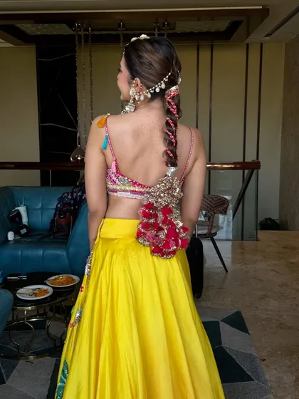A look at the beautiful braided hairstyle with a traditional 'gul prandi'. The entire look, from hair to makeup, is a celebration of colour and tradition.