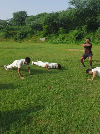 Core strength and conditioning are non-negotiable. Players engage in bodyweight exercises like push-ups and squats as part of our comprehensive junior cricket fitness program to build functional strength for batting and bowling.