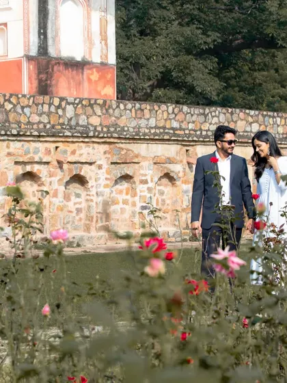I often work at Delhi's beautiful historical monuments. This portrait, taken in a garden near a classic structure, shows how I blend elegant poses with natural surroundings for timeless couple photographs.