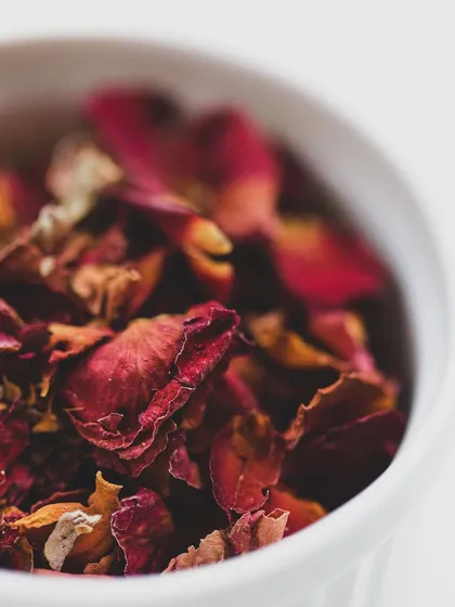 Dried rose petals in a bowl. We teach our students about this exotic ingredient's role in frontier cuisines, from garam masalas to biryanis.