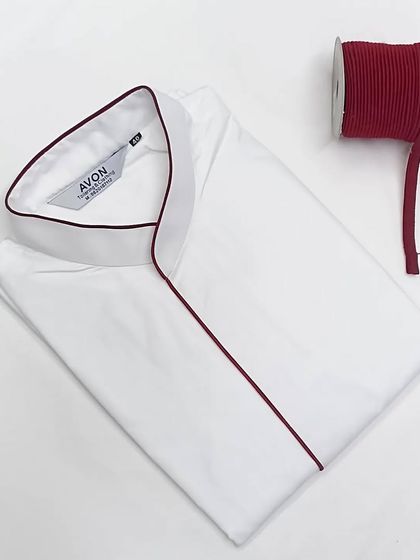 This white saya kurta is finished with a deep maroon piping. This color combination is both classic and striking.