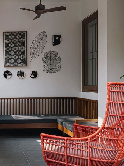An outdoor seating area provides a comfortable and stylish space for relaxation, featuring modern rattan furniture and curated wall art.