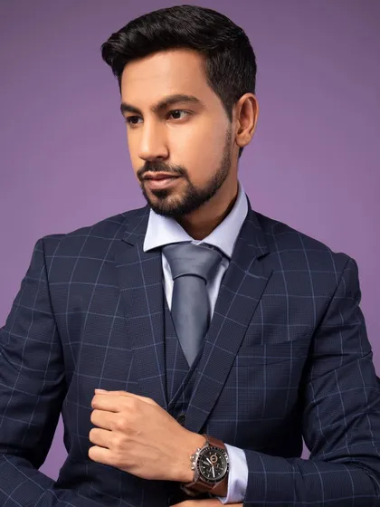 A classic pose for a corporate portrait. The three-piece suit and watch add to the professional look, making it perfect for a business leader or executive.