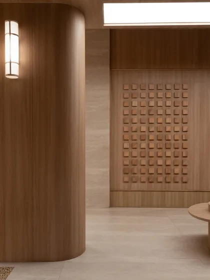 A corner detail, where a curved wooden wall meets a textured panel, showcasing the precise joinery and material harmony.