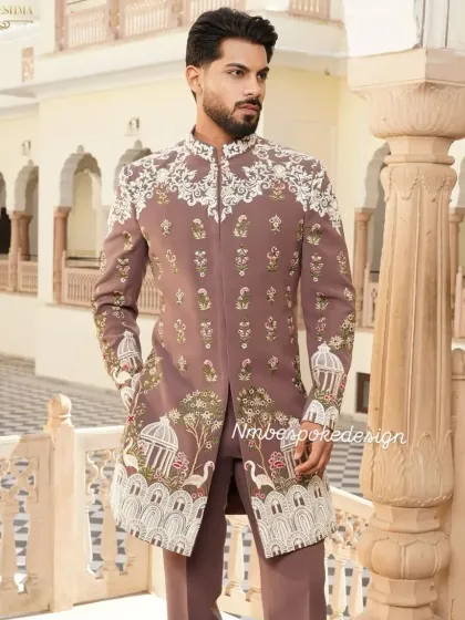 This custom Indowestern sherwani in a unique peach tone showcases my team's artistry. The intricate white embroidery features delicate birdcage and floral motifs, making it an exceptional choice for a sophisticated wedding guest or groom.