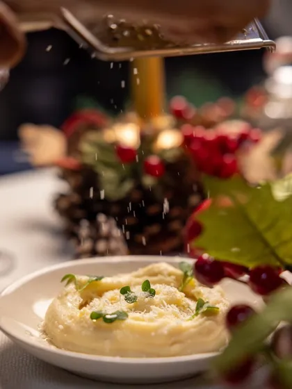 The motion of grating fresh parmesan over a dish captures the freshness and quality of the ingredients we use in our festive meals.