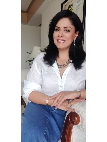 A close-up portrait showing the layered necklace I paired with the white linen shirt and denim skirt.