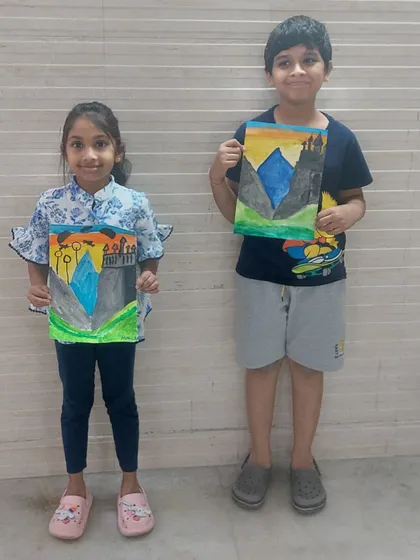 Two students proudly holding up their Hogwarts castle paintings. It's so rewarding to see their love for a story translate into beautiful art.
