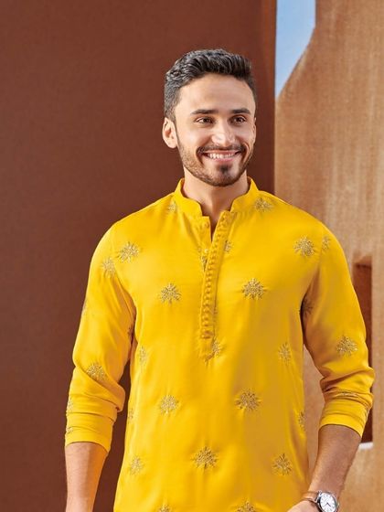 Embrace the spirit of Diwali with this bright yellow kurta featuring delicate, star-like embroidery. It's a look that radiates warmth and festive charm.