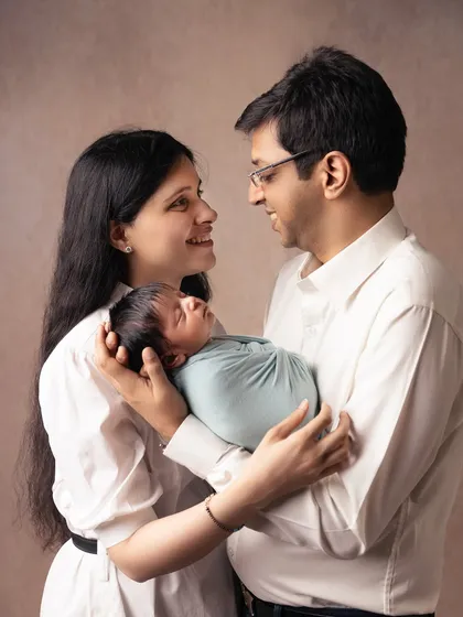 In this shot, the parents look at each other, sharing a smile over their precious newborn. It’s a beautiful portrait of their partnership and the new chapter they are beginning together.