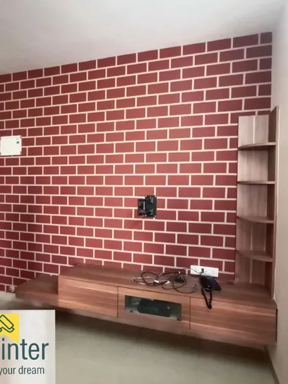 We create realistic faux brick walls for a classic industrial or rustic feel. This red brick pattern is painted as a feature wall for a TV unit, adding texture and warmth to the living area.