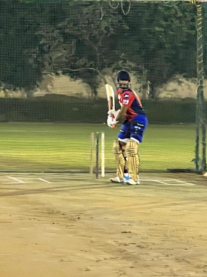 IPL all-rounder Rishi Dhawan gets ready to face bowlers during a night practice session. Our well-lit pitches allow for extended training hours, a crucial advantage for professional athletes.