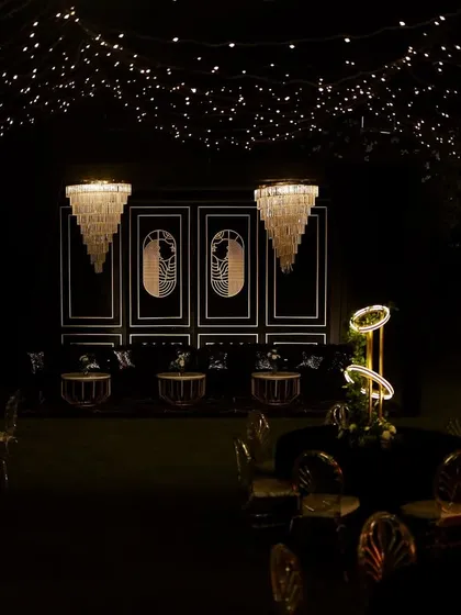 The full Sangeet layout, with the fairy light ceiling, the Art Deco lounge, and the modern illuminated tables creating a multi-layered and visually rich experience.