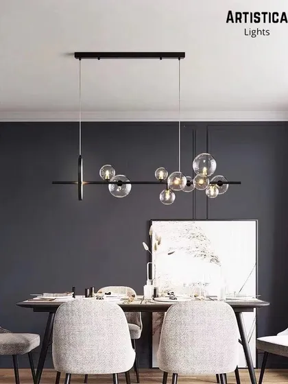 Perfect for a contemporary dining room, this linear chandelier features a series of bubble glass globes along a sleek black bar. It provides excellent task lighting over a long table while adding a touch of modern elegance and visual interest.