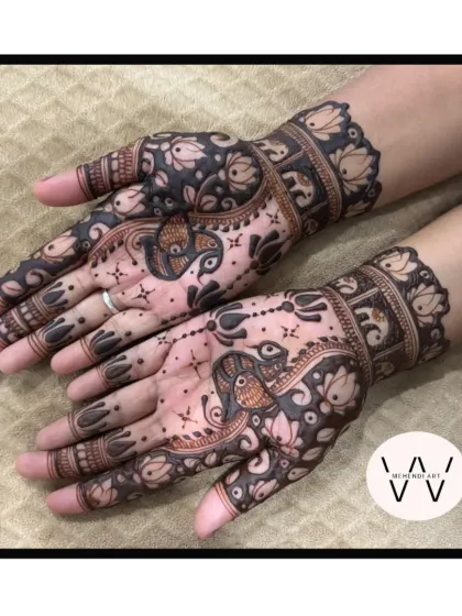 The fresh application of the same peacock and elephant design, showing the contrast before the stain develops.