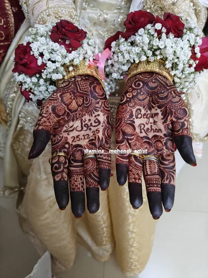 I love weaving your story into the mehendi. This design features the phrase 'Qubool Hai' and the wedding date, making it a beautiful and personal memory of the special day.