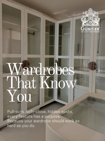 A walk-in closet that truly understands your needs. This L-shaped configuration features glass doors, an island with accessory drawers, and smart compartments for everything.