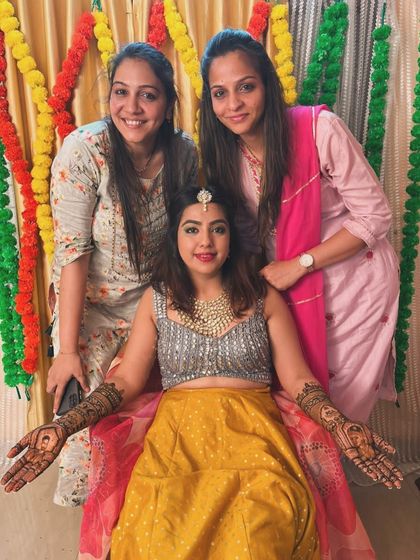 A happy moment with the bride and our team. Her complete bridal mehndi, featuring portraits and traditional patterns, looks stunning.