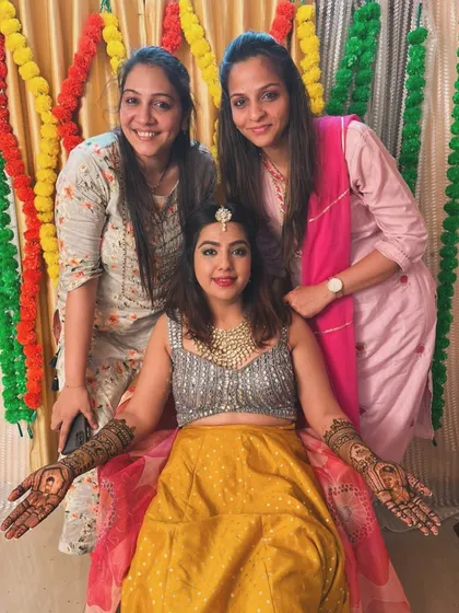 A happy moment with the bride and our team. Her complete bridal mehndi, featuring portraits and traditional patterns, looks stunning.