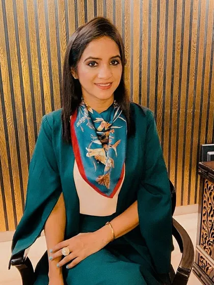 This is how I style myself for an important professional meeting. The structured green blazer paired with a complementary printed scarf creates a look that is both authoritative and approachable, ensuring you make a memorable first impression.