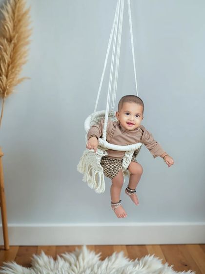 Look who's sitting up! This sitter session, for babies around 6 to 9 months old, is perfect for capturing their newfound skills. This macrame swing is a beautiful and safe prop for these shots.