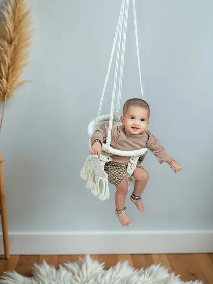 Look who's sitting up! This sitter session, for babies around 6 to 9 months old, is perfect for capturing their newfound skills. This macrame swing is a beautiful and safe prop for these shots.