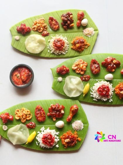 Three non-veg leaf meal magnets, each with a slightly different arrangement of delicious dishes.