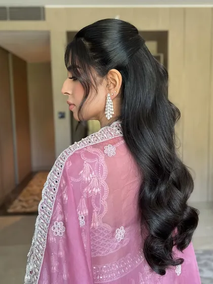 A beautiful side view of the half-up hairstyle, showing its volume and bounce.