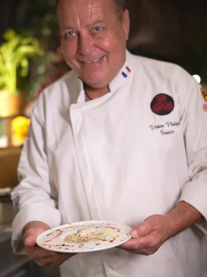 Chef Didier Philippe from France, another of our esteemed international chefs, smiles as he displays a perfectly crafted dish.