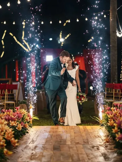 A grand entrance for a fun-loving couple. The aisle is lit up with a line of cold pyrotechnics, creating an electrifying path for their reception entry and getting the party started.