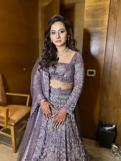 An open hairstyle with soft waves, perfect for an engagement bride who wants a glamorous yet understated look.