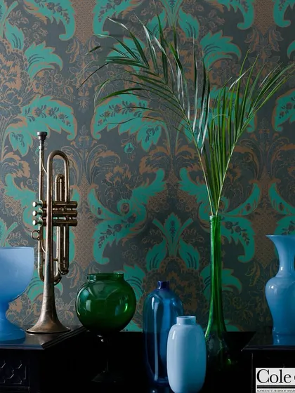 A classic damask pattern from Cole & Son is given a modern twist with a bold teal and bronze colorway. This wallpaper adds a layer of historic grandeur and sophistication to the space.