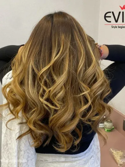 A back view showcasing the full effect of this long, wavy balayage. The color looks vibrant and healthy, flowing seamlessly from top to bottom.