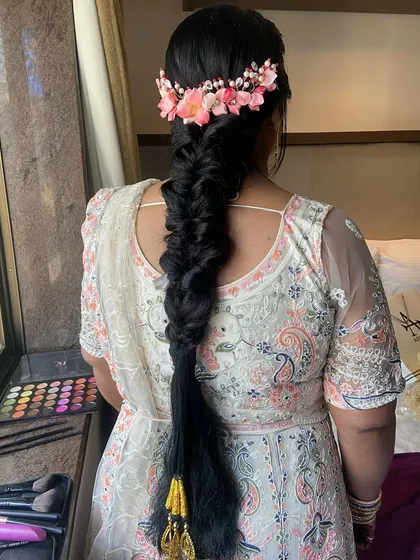 The full view of this incredible long fishtail braid, complete with a floral crown and traditional parandi tassels at the end.