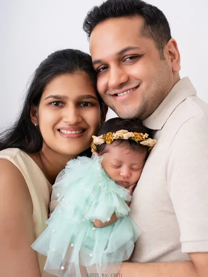A happy family of three. The smiles on their faces say it all. This is the joy that a new baby brings.