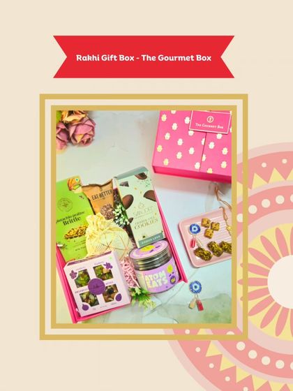 This Rakhi Gift Box comes in a vibrant pink box and is filled with a fun mix of treats like pistachio brittle, atom eats, and an evil-eye rakhi for good vibes.