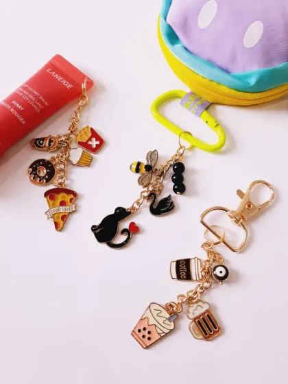A collection of custom charm keychains that match your vibe. This image features a foodie chain, a coffee and boba lover's chain, and an animal-themed chain.