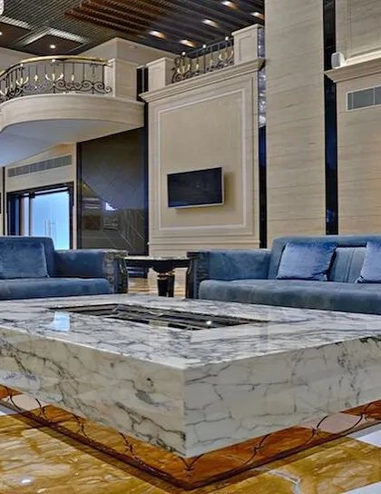 We designed bespoke furniture for the A-Class Marble showroom, including this massive center table crafted from a single block of marble. This piece serves as a powerful statement of the brand's product and our ability to integrate it into functional, luxurious design.