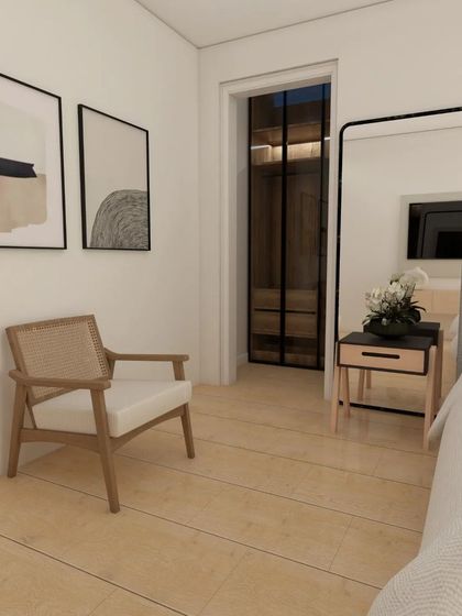 Another view of the Scandinavian bedroom design, showing a comfortable reading corner with a cane chair.