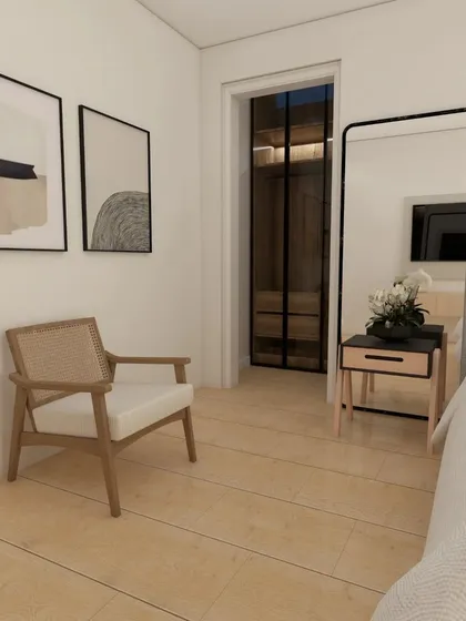Another view of the Scandinavian bedroom design, showing a comfortable reading corner with a cane chair.