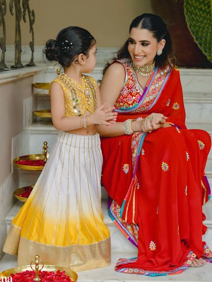 A sweet moment between mother and daughter. Her makeup is soft and elegant, perfect for the occasion.