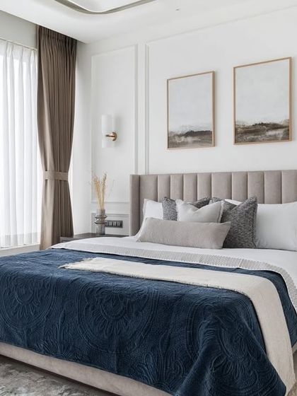 This bedroom is a testament to the beauty of simplicity. With a neutral color palette, classic wall mouldings, and soft, layered textiles, the space feels calm, elegant, and timeless.