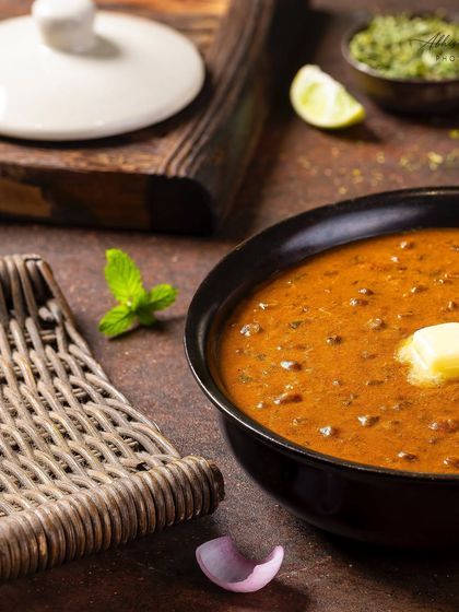 A styled shot of Dal-e-Rubaruh, emphasizing the dollop of butter and fresh mint garnish.
