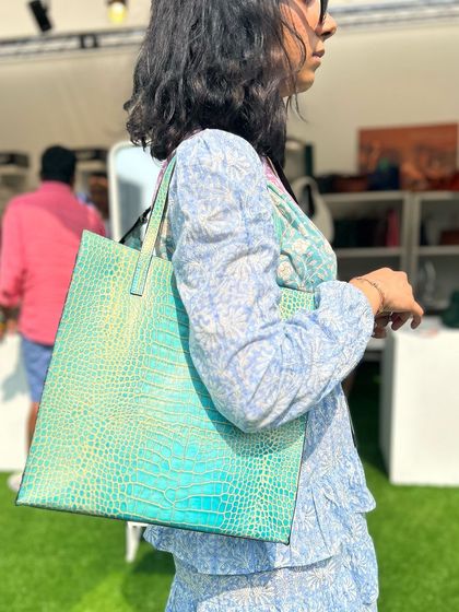 A throwback to a summer event with our Eli Tote in a stunning Marine Blue croc-print. This tote is a perfect example of a practical bag that doesn't compromise on style.