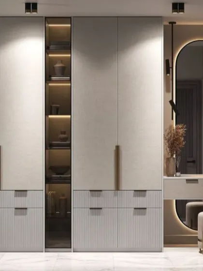 My custom wardrobes are designed for both beauty and function. This unit combines closed storage, glass display shelves with internal lighting, and a dedicated dressing table with a backlit mirror.
